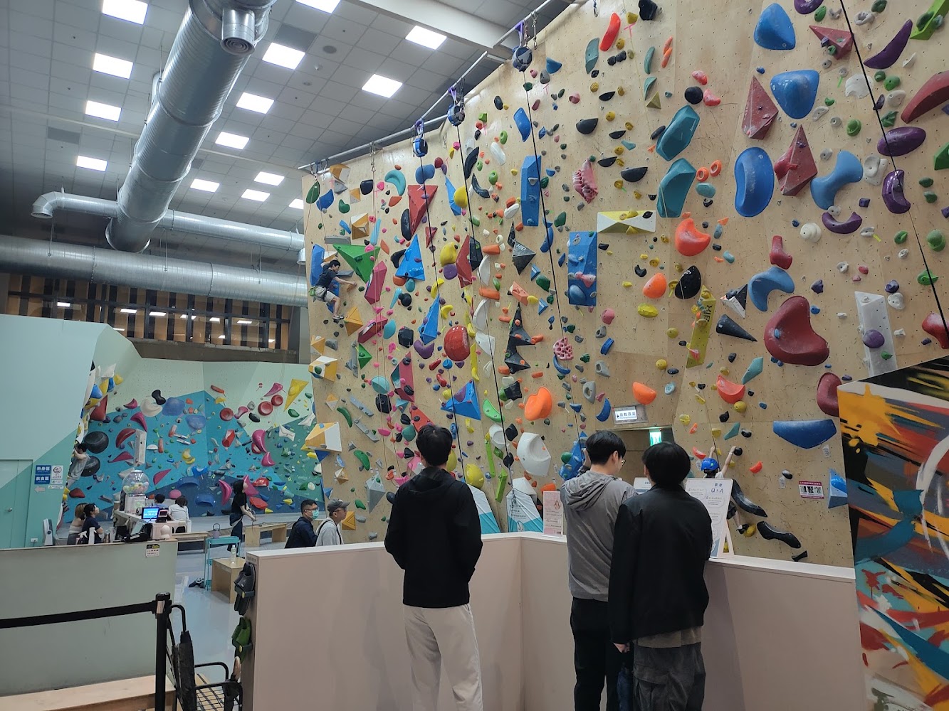 室內攀岩館有各種顏色攀岩牆與體驗者