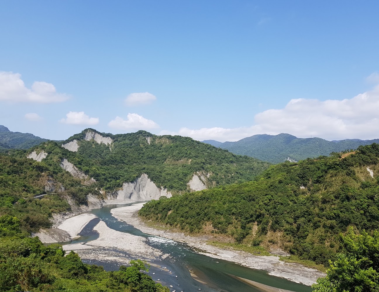 青翠山脈與蜿蜒河流，天空藍天白雲