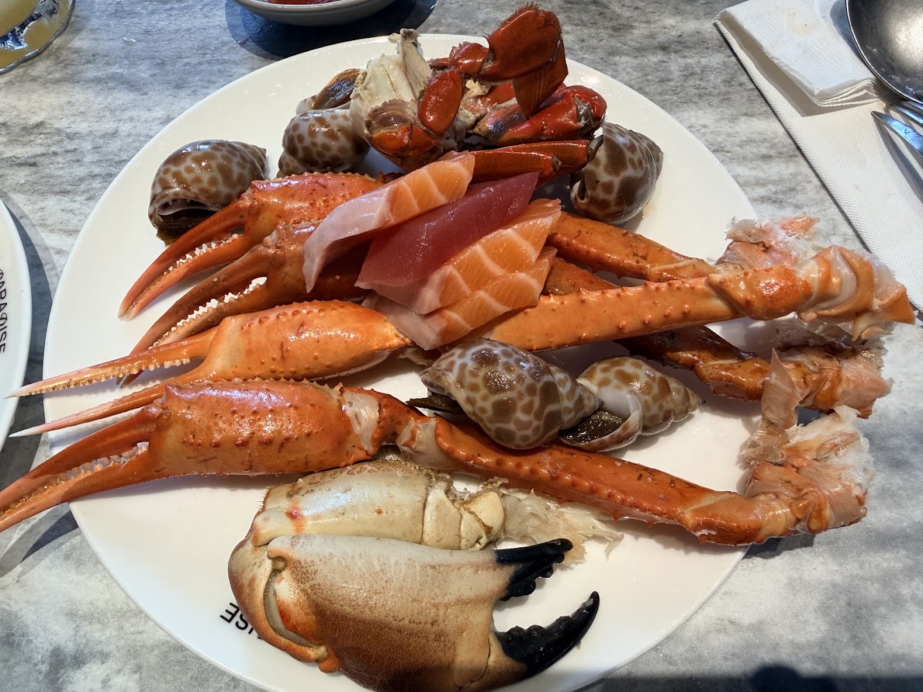 一盤豐盛海鮮包含蟹腳與生魚片