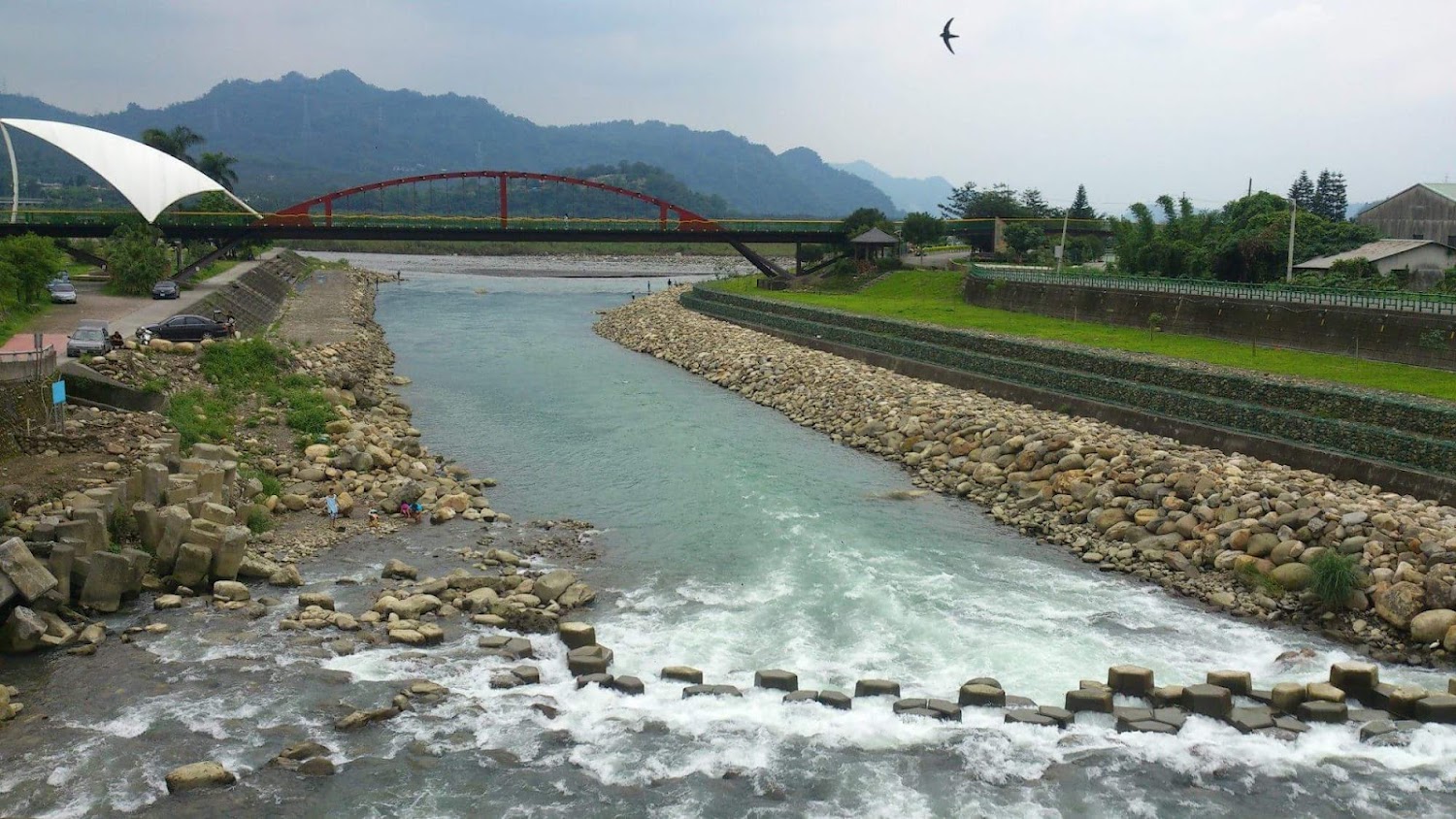 南投河流石岸步道與紅色拱橋