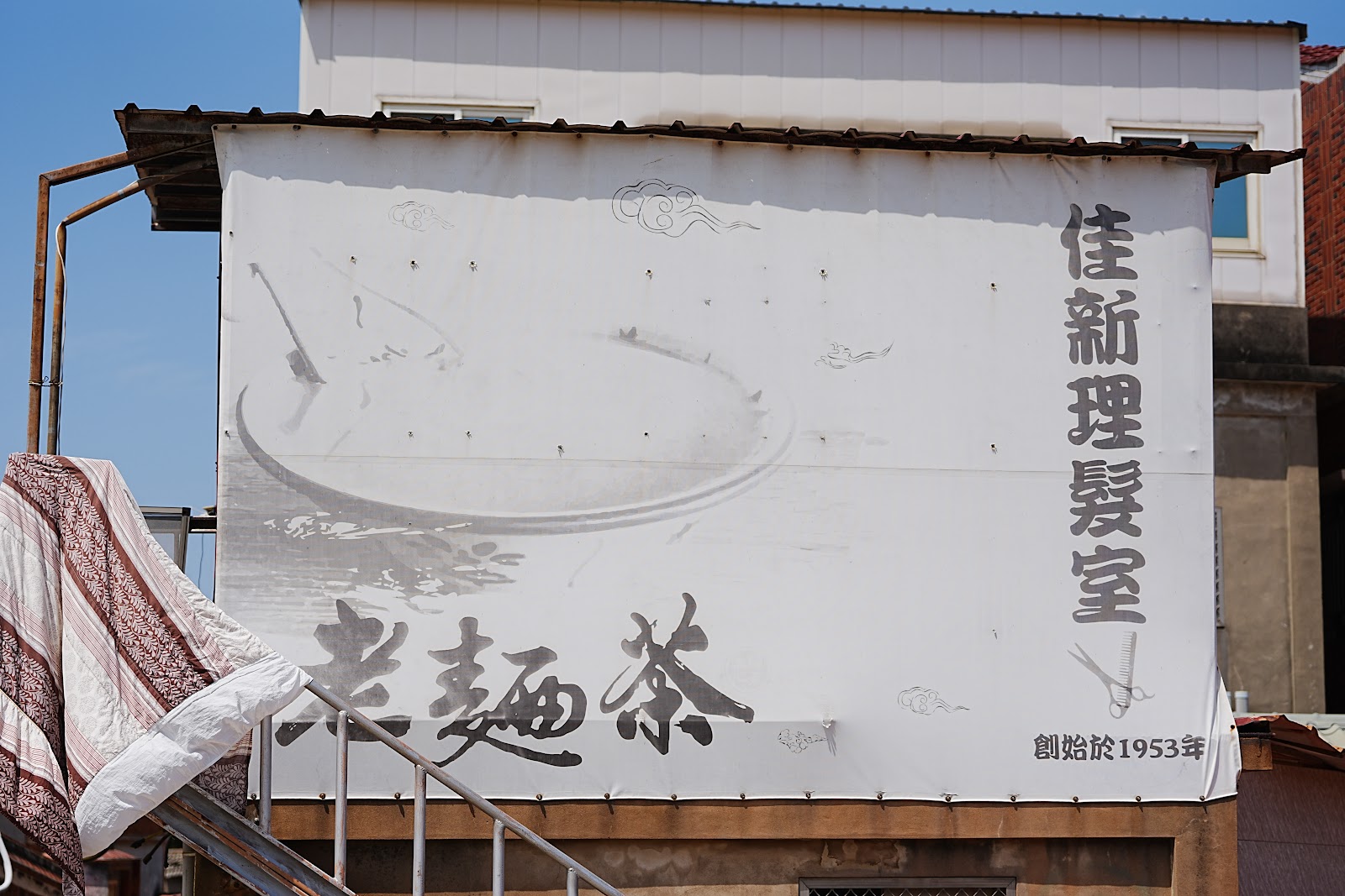 南山聚落創始於1953年老理髮室手繪招牌布幔