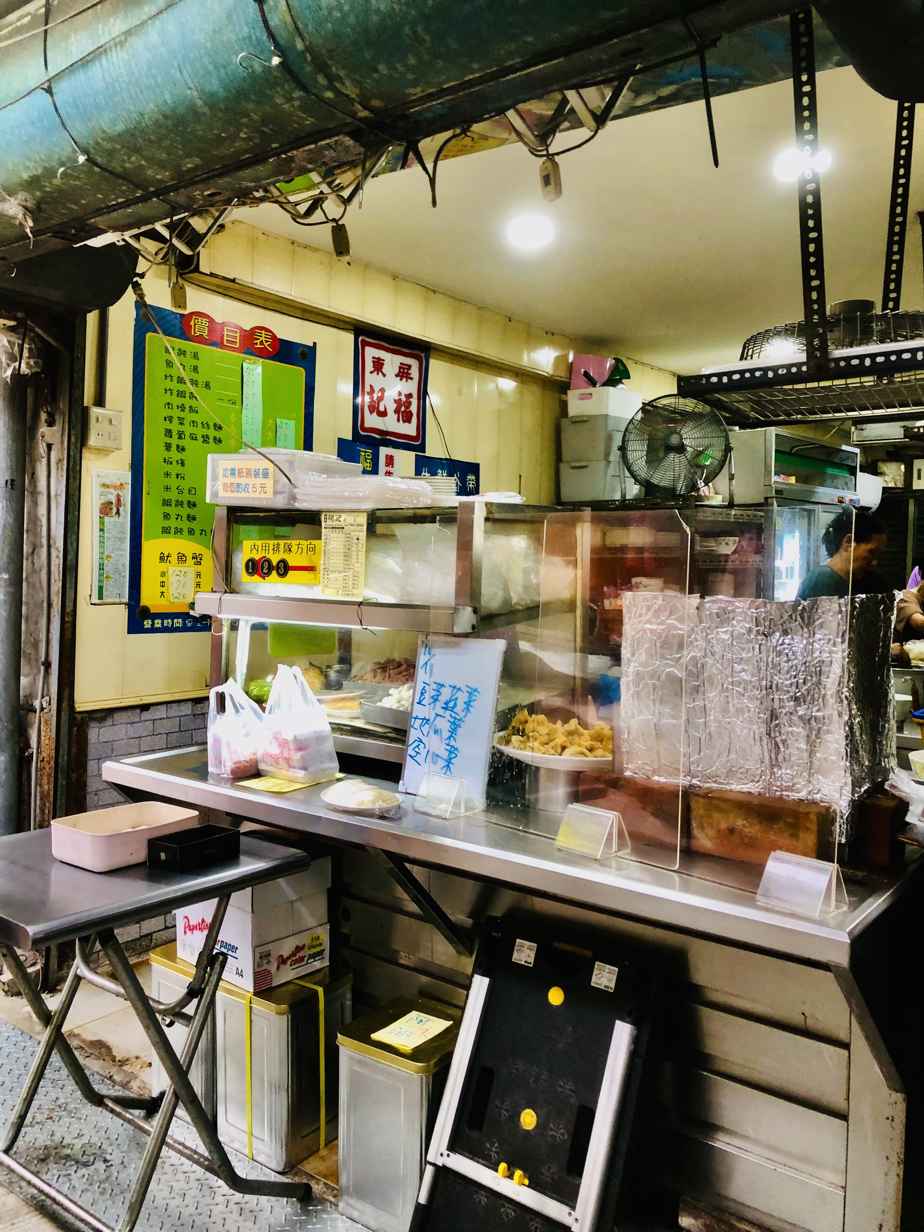 傳統小吃店攤位與價目表、簡易桌椅畫面