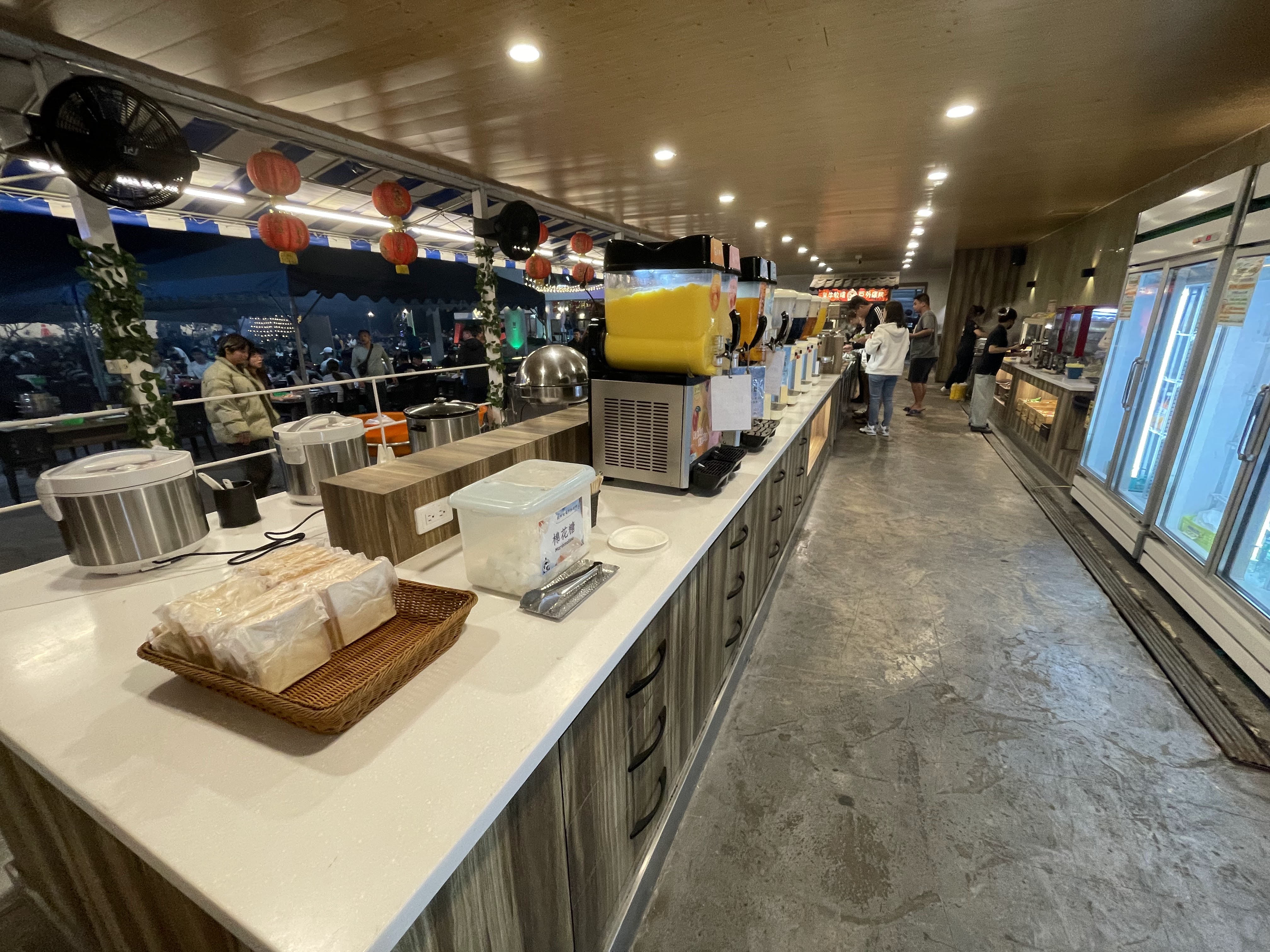 自助餐飲區有飲料機、白飯鍋、冰箱和吐司等