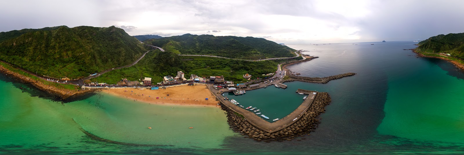 大武崙澳底漁港與白沙灘空拍全景，山海交界的灣岸地形