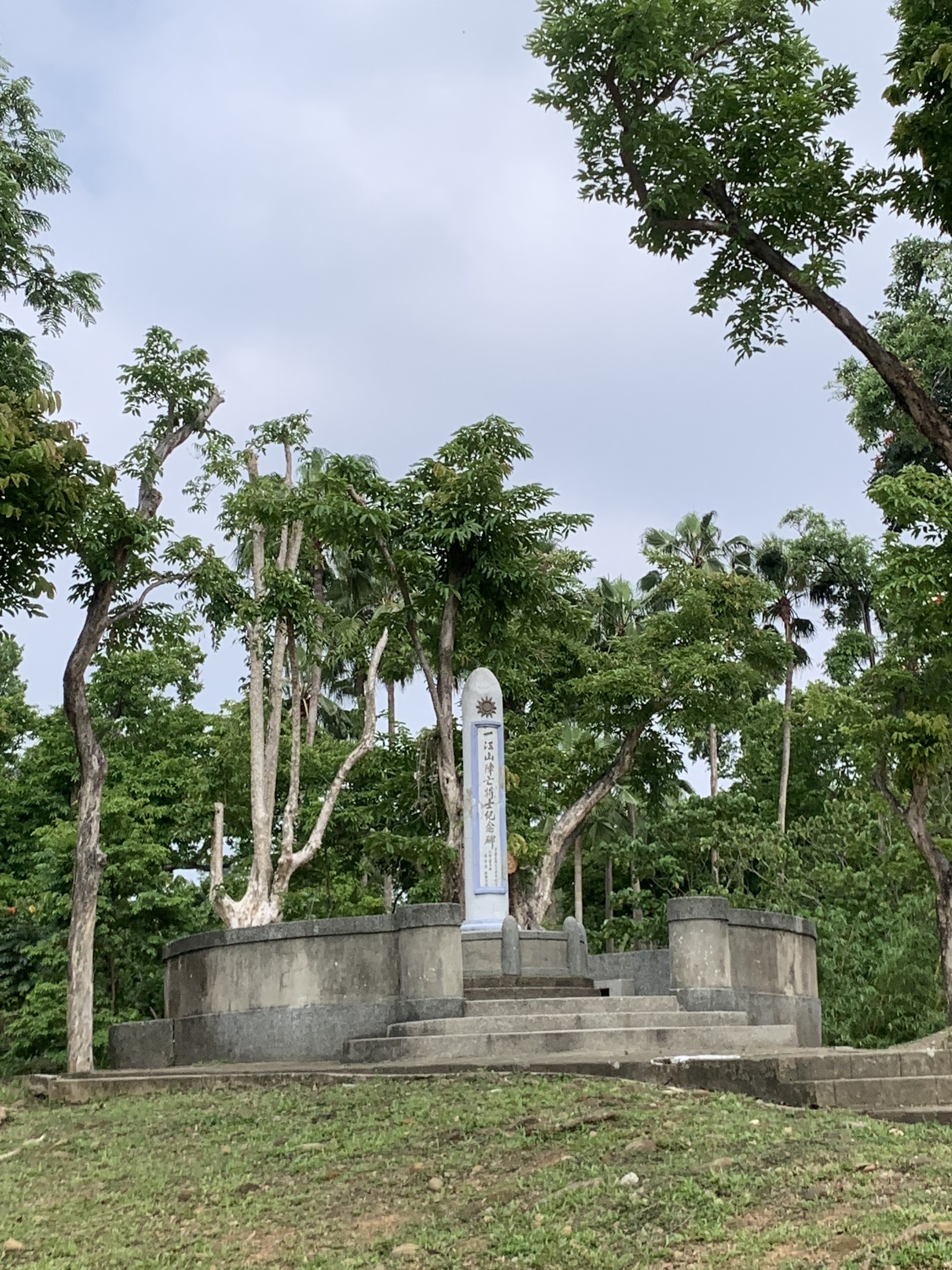 嘉義公園-嘉義公園內的歷史紀念碑石柱,立在小丘上、周圍林木環繞,氣氛清幽
