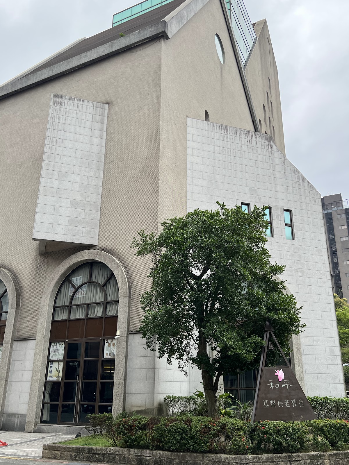 臺北和平教會清水模現代建築外觀,入口大樹與招牌