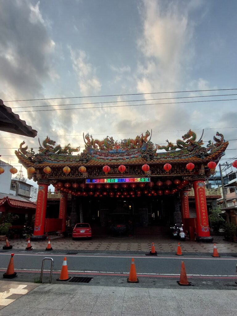 花蓮城隍廟牌樓全景，夕陽天空下的龍形屋脊