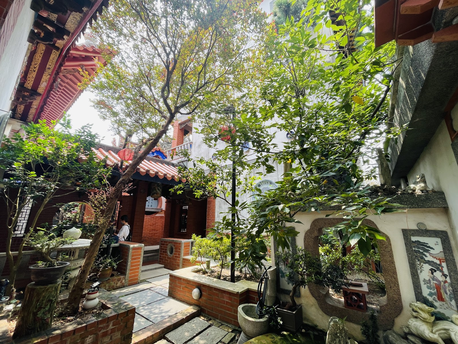 雲林持法媽祖宮－庭園造景一角，綠意盆栽與紅磚雕花窗框