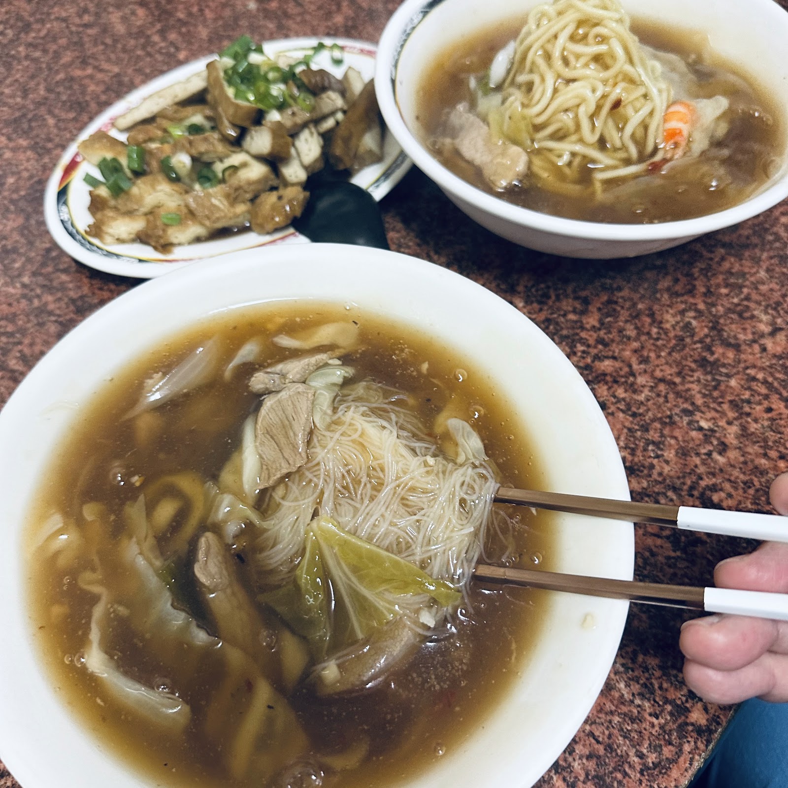 崁頂魯米粉與滷味小菜俯拍,筷子夾起米粉特寫