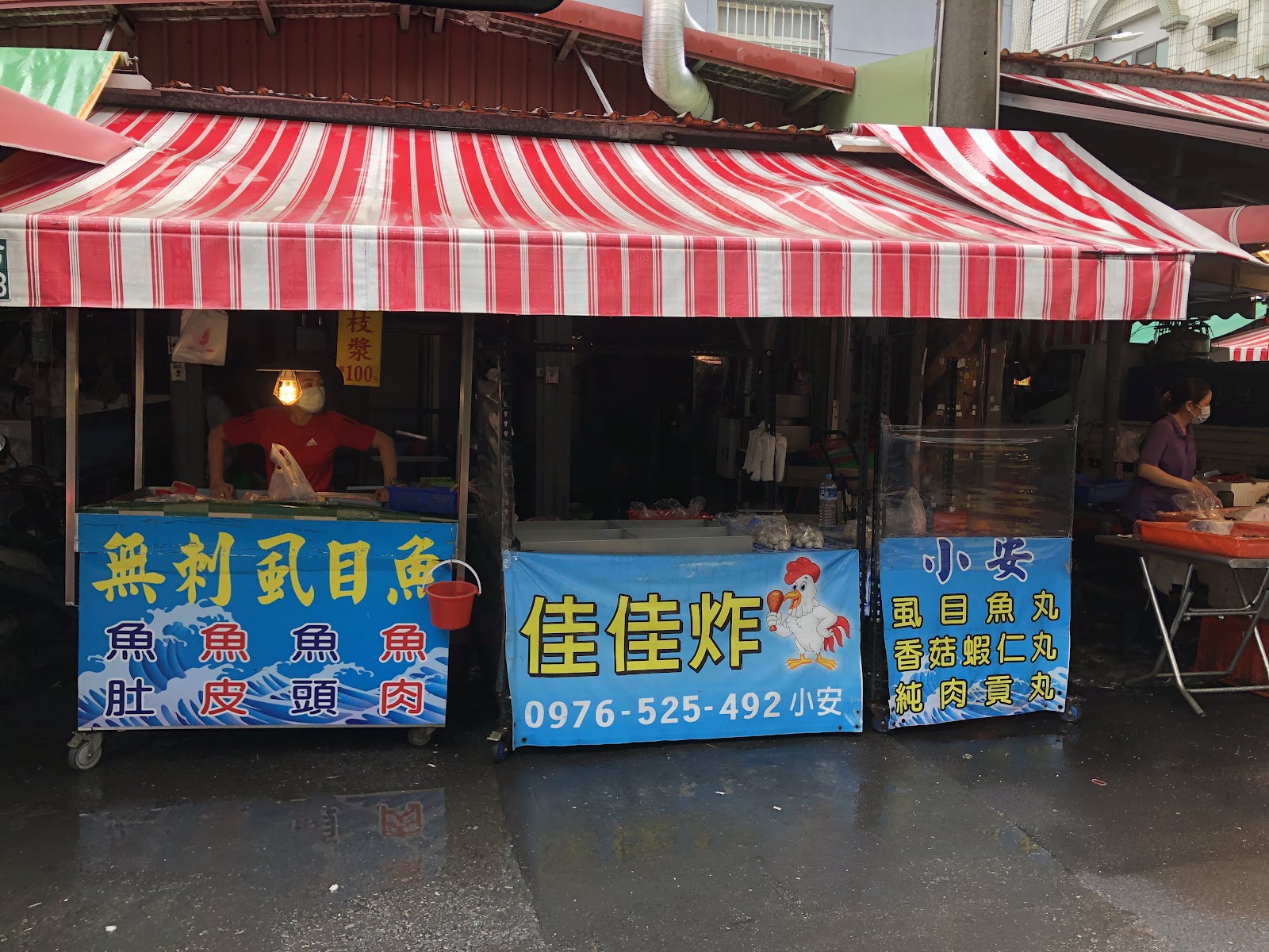二苓市場紅白條紋棚下的虱目魚攤,招牌列出魚肚魚皮魚頭魚肉