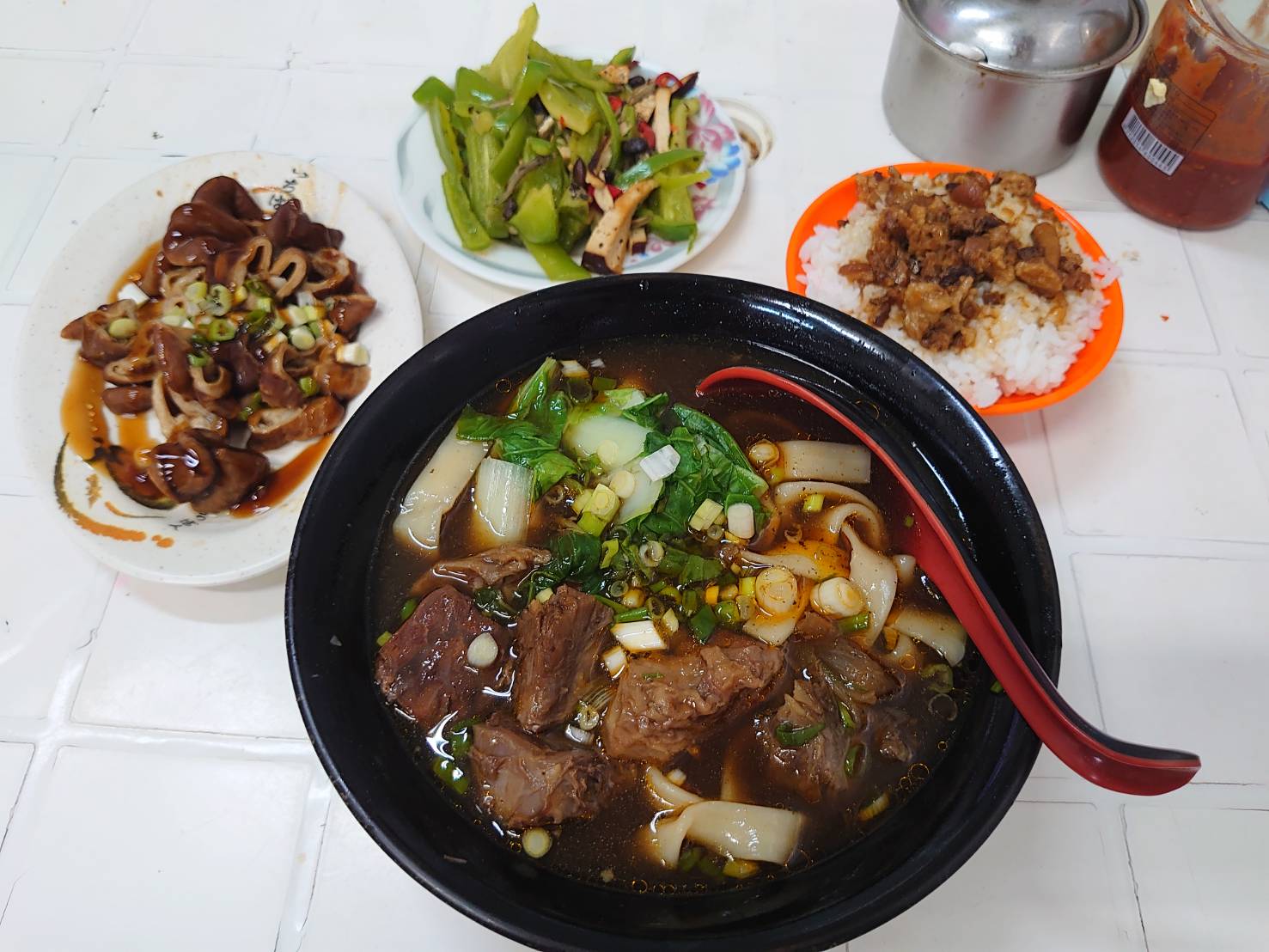 店仔口牛肉麵的招牌牛肉湯麵套餐，搭配滷味小菜與季節時蔬
