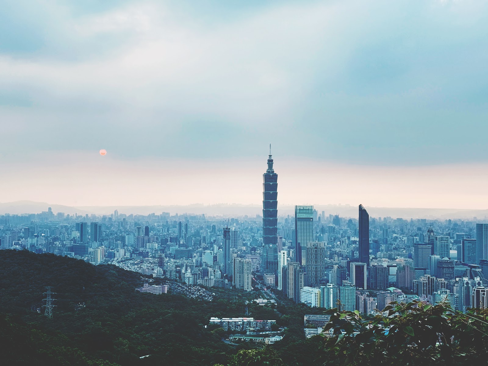 居高臨下遠眺台北101與整個台北市天際線，黃昏淡粉色天空