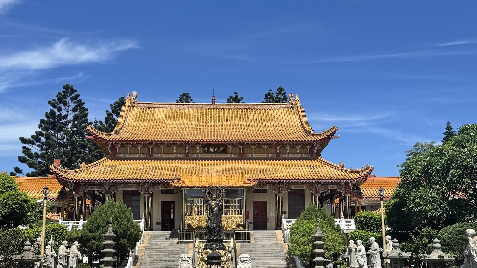 圓光禪寺大殿前銅鑄韋馱菩薩立像與兩側石雕羅漢，山門階梯全貌