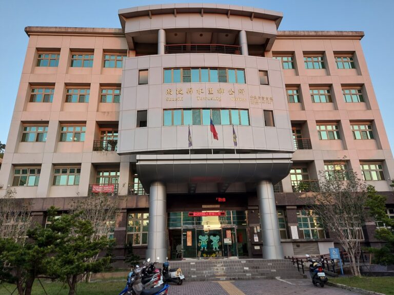 南投縣水里鄉公所建築正面全景,圓弧造型塔樓與金色招牌