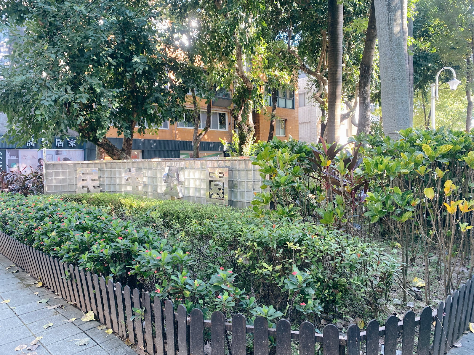 台北松山區民生社區民生公園－民生公園社區入口鏤空字牆，灌木環繞