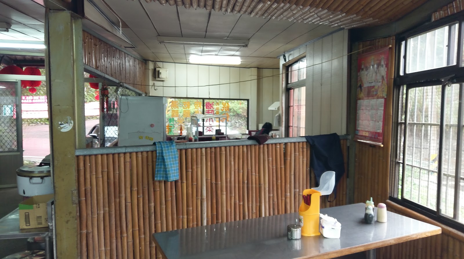 高山青小吃店室內用餐區，竹編牆面與木桌