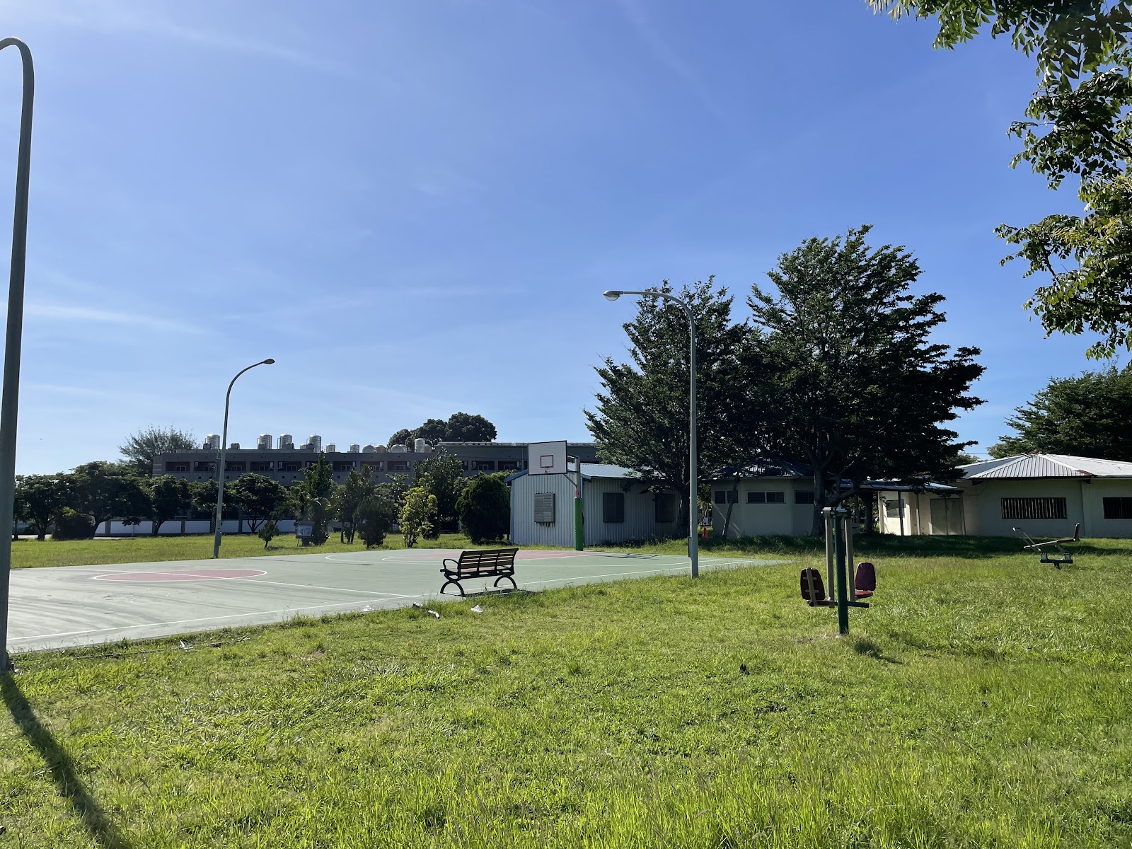 嘉新社區公園籃球場與健身器材,草地前景藍天白雲