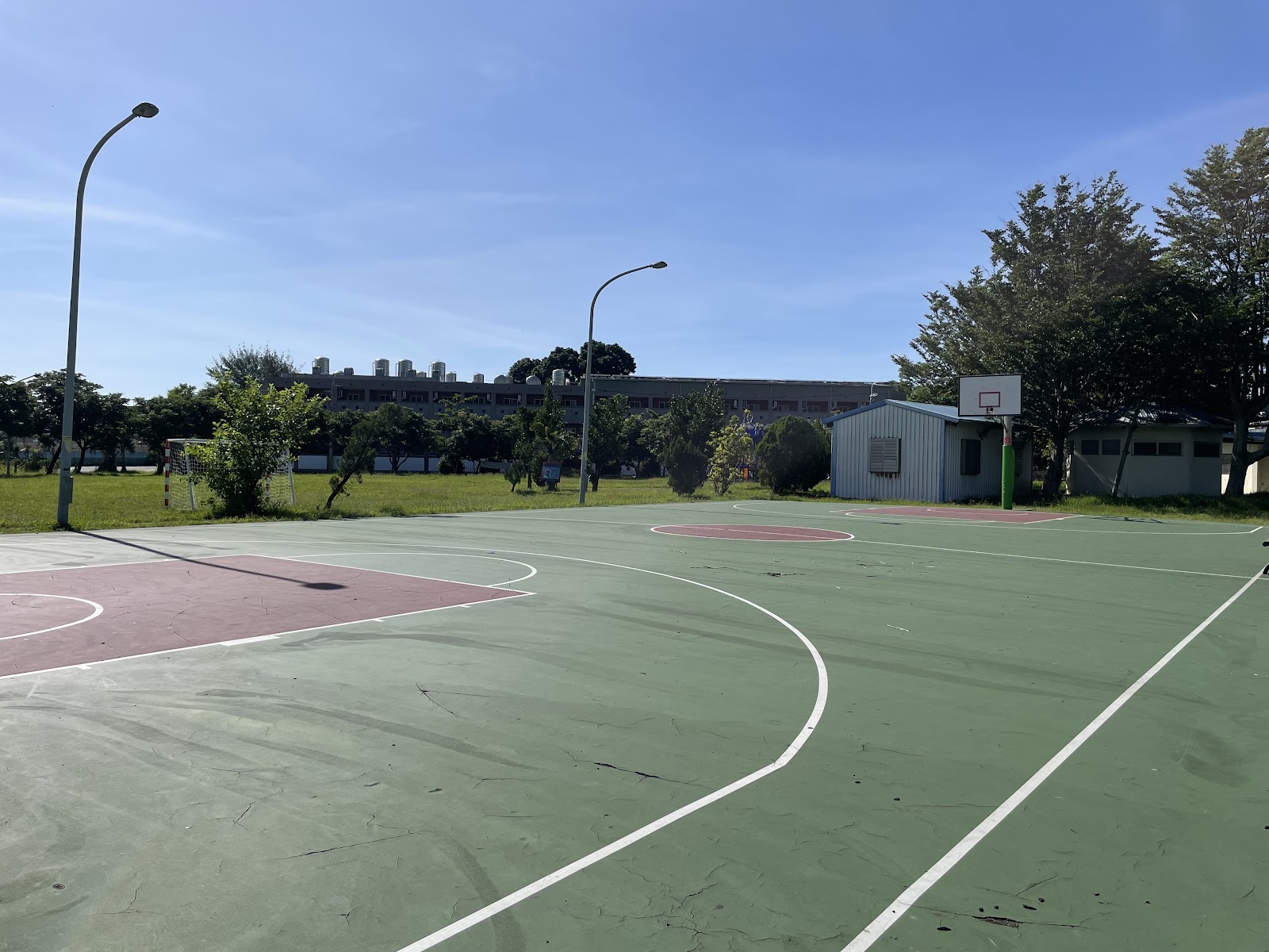 嘉新社區公園籃球場近景,藍天綠樹環繞